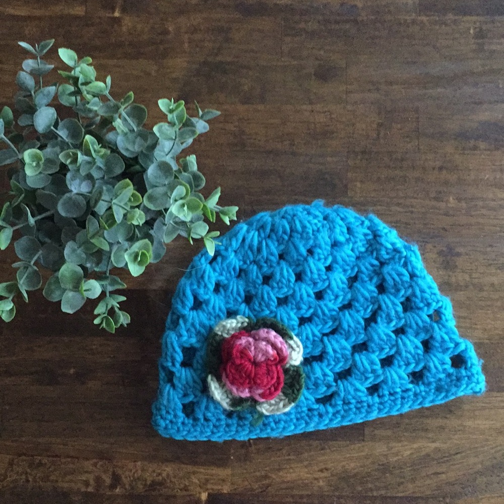Blue crochet knit hat with flower detail